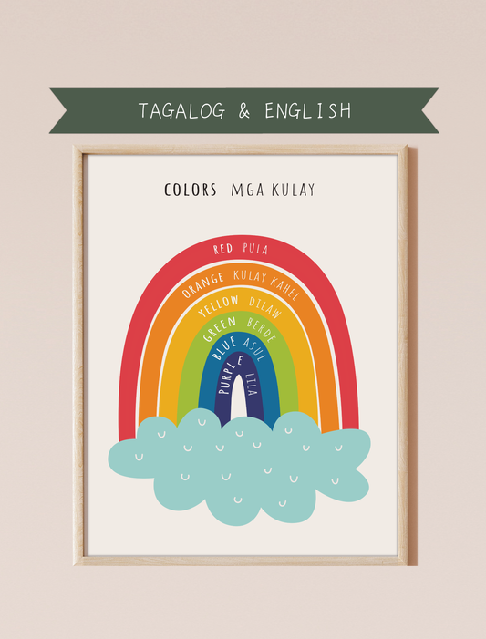 A bilingual educational print featuring colors labeled in English and Tagalog. The print displays cute, colorful rainbow featuring the following colors: red, orange, yellow, green, blue and purple . This bilingual display aids in language acquisition and cross-cultural learning and has a perfect aesthetic for a baby nursery, classroom, or other decor. 