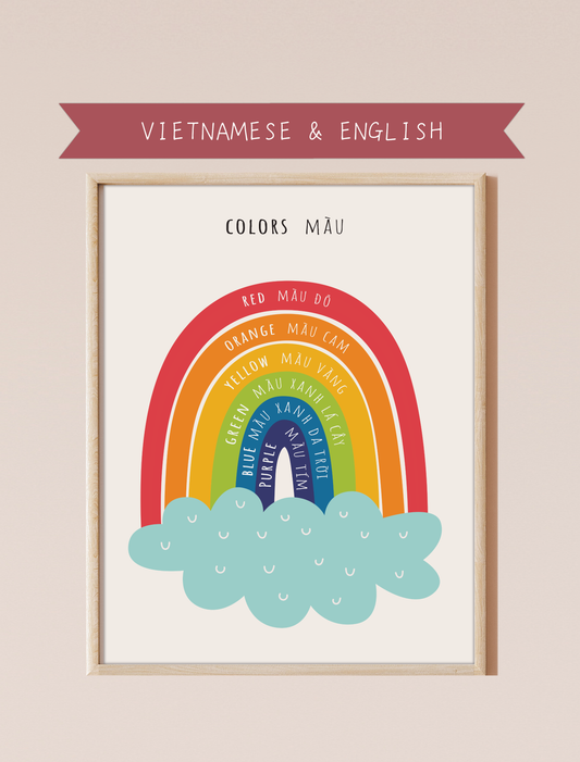 A bilingual educational print featuring colors labeled in English and Vietnamese. The print displays cute, colorful rainbow featuring the following colors: red, orange, yellow, green, blue and purple . This bilingual display aids in language acquisition and cross-cultural learning and has a perfect aesthetic for a baby nursery, classroom, or other decor. 
