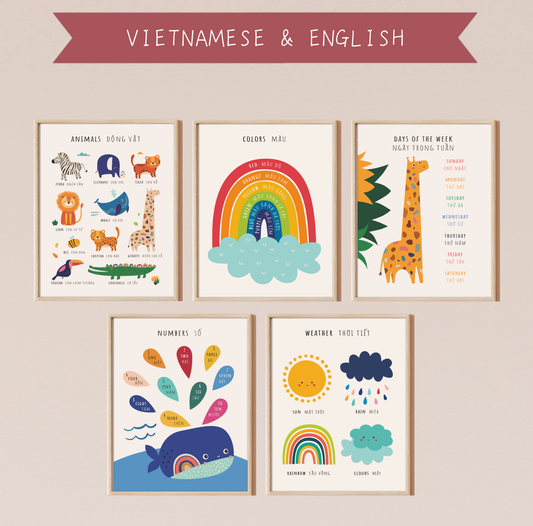 Five bilingual educational prints framed in light oak hanging on a pinkish wall featuring cute, colorful illustrations of animals, colors, days of the week, numbers and the weather labeled in English and Vietnamese. This bilingual display aids in language acquisition and cross-cultural learning and has the perfect aesthetic for a baby nursery, classroom, or other decor. 